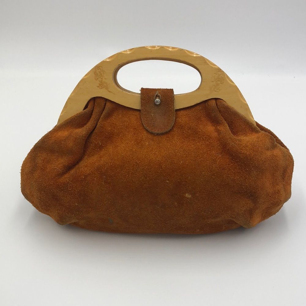 Vintage 1970s era leather handbag with wooden handles and engraved flowers